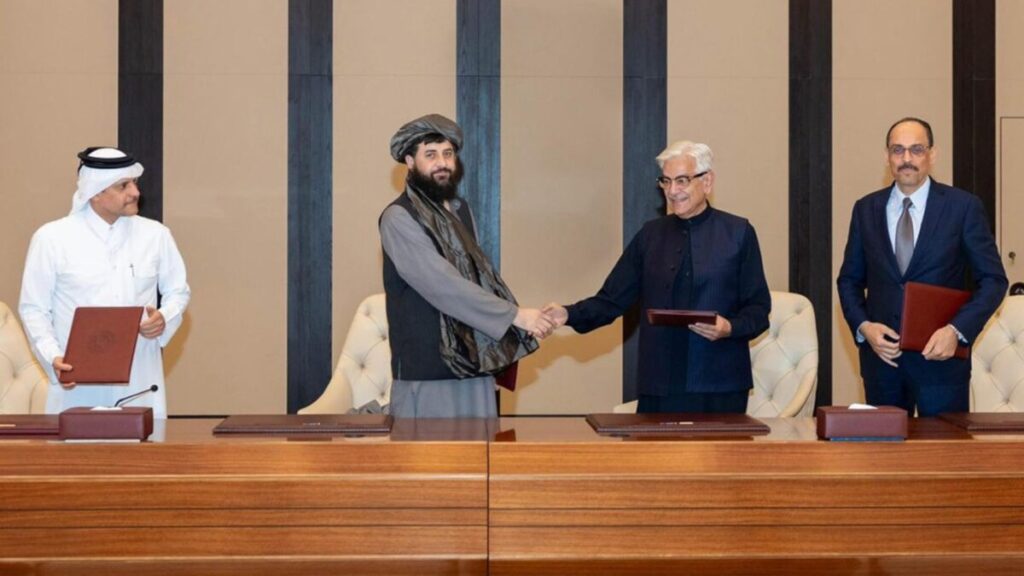 Taliban and Pakistani defense ministers shake hands after signing the Taliban-Pakistan ceasefire agreement in Doha, mediated by Qatar, October 2025.
